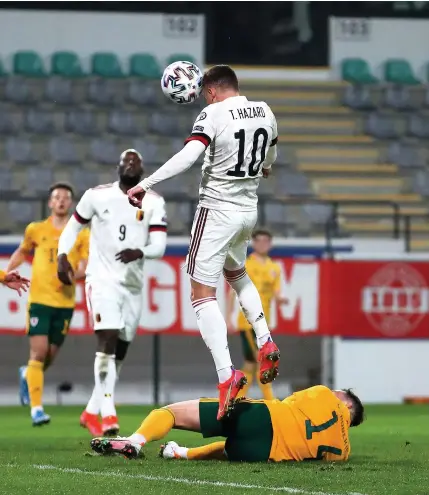  ?? Dean Mouhtaropo­ulos/getty Images ?? Thorgan Hazard rises above a prone Connor Roberts to head in Belgium’s second goal.