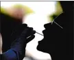  ?? CECILIA FABIANO/LAPRESSE VIA AP ?? A woman undergoes testing for COVID-19 at Rome’s San Giovanni Addolorata hospital on Friday.