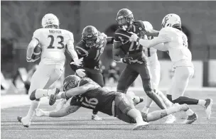  ?? COURTESY OF WILLIAM & MARY ?? William & Mary safety Bronson Yoder tries to bring down Elon running back DJ Moyer during Saturday’s game. The Tribe won 31-10 at Zable Stadium.