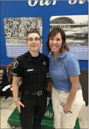  ?? PHOTO COURTESY OF KATHRYN SEARLE ?? The Central Macomb Optimist Foundation will host a Spring Into Action event to benefit the Shop with a Sheriff program. Pictured are Macomb County Sheriff’s Office Deputy Savannah Johns and Optimist Foundation member Kathy Farnum at a prior Shop with the Sheriff event.