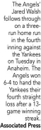  ?? Associated Press ?? The Angels’ Jared Walsh follows through on a threerun home run in the fourth inning against the Yankees on Tuesday in Anaheim. The Angels won 6-4 to hand the Yankees their fourth straight loss after a 13game winning streak.