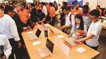  ?? Virendra Saklani/Gulf News ?? Visitors examine products at Xiomi’s newly opened second authorised Mi store at Deira City Centre in Dubai.