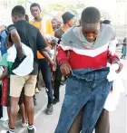  ?? ?? Former street children receive clothes sourced by First Lady Dr Auxillia Mnangagwa at the skills developmen­t centre in Mbare, Harare, yesterday morning