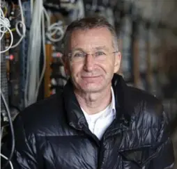  ??  ?? Helmut Rauth, director of Genesis Mining, next to computer rigs that “mine” Bitcoin around the clock in Keflavik, Iceland, increasing electricit­y demands.