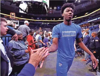  ?? JOE RONDONE/THE COMMERCIAL APPEAL ?? Memphis Tigers center James Wiseman high-fives fans after their 68-58 win over Little Rock on Wednesday.