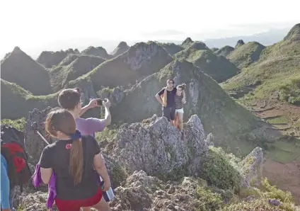  ?? SUNSTAR FILE ?? TOURISM BOOM. Tourists take a photo at the famous Osmeña Peak in Dalaguete, Cebu. Philippine Veterans Bank chairman and chief executive officer Roberto de Ocampo says tourism is one of the country’s strengths to achieve high economic growth this year.