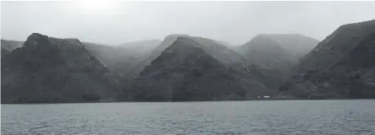  ?? Photos by Christophe­r Torchia, The Associated Press ?? The volcanic cliffs of remote St. Helena island are covered in fog. Tourists who take a cruise out of Jamestown, the island’s capital, can sometimes see pods of dolphins, humpback whales and seabirds nesting in the walls of rock along the shoreline.