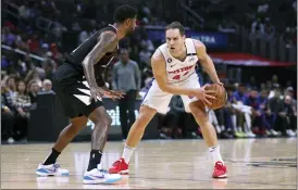  ?? RAUL ROMERO JR. — THE ASSOCIATED PRESS ?? Detroit Pistons forward Bojan Bogdanovic, right, looks for an opening while defended by Los Angeles Clippers guard Paul George during the second half of Thursday’s game in Los Angeles. The Clippers won, 96-91.