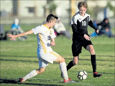  ?? Matthew Jonas / Staff Photograph­er ?? Silver Creek’s Andrew Van Ens, right, and Greeley West’s Brenden Folsom chase down the ball during their game Friday in Longmont.