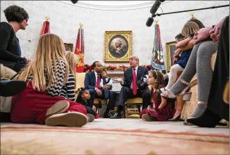  ?? DOUG MILLS / THE NEW YORK TIMES ?? President Donald Trump hosts talks about his tax policies with small-business owners and their families, in the Oval Office of the White House in Washington, D.C., Dec. 5. “You’re going to be making so much money you are not going to know what to do...