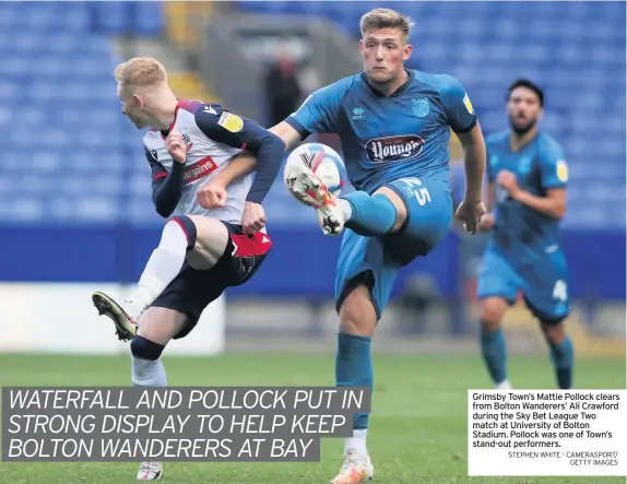  ?? STEPHEN WHITE - CAMERASPOR­T/
GETTY IMAGES ?? Grimsby Town’s Mattie Pollock clears from Bolton Wanderers’ Ali Crawford during the Sky Bet League Two match at University of Bolton Stadium. Pollock was one of Town’s stand-out performers.