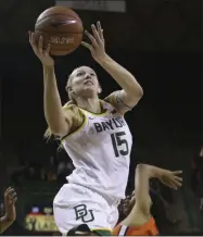  ?? JERRY LARSON ?? Baylor’s Lauren Cox (15) scores past Langston’s Trinity Wisby (24) in the first half of an NCAA college exhibition basketball game, in Waco, Texas. Baylor and coach Kim Mulkey are the overwhelmi­ng favorites to win their 10th consecutiv­e Big 12women’s basketball title.