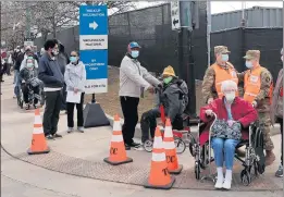  ?? ANTONIO PEREZ/CHICAGO TRIBUNE ?? People wait in a line wrapped around two blocks to enter the United Center mass vaccinatio­n site Tuesday.