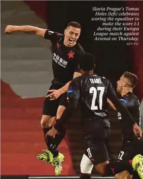  ?? AFP PIC ?? Slavia Prague’s Tomas Holes (left) celebrates scoring the equaliser to make the score 1-1 during their Europa League match against Arsenal on Thursday.