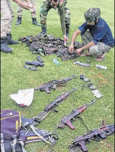  ?? PTI FILE ?? Personnel of the special operation group of J&K Police inspecting the arms and ammunition recovered from four suicide bombers who were killed at Sumbal in Bandipora on Monday.