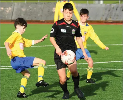  ??  ?? Dylan Moriarty, Killorglin (yellow) and Ken Wright Camp Jnr FC in action in Mounthawk Soccer grounds Tralee during their clash in the Under 15 Premier Photo by Domnick Walsh / Eye Focus