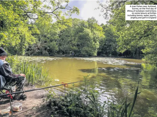  ??  ?? A man fishes near Ashtead, Surrey, on the first day of lifting of lockdown restrictio­ns on some leisure activities including tennis, water sports, angling and golf in England