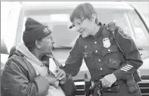  ?? ElaiNe ThompsoN / ap ?? Seattle Police Officer Debra Pelich, right, wears a video camera on her eyeglasses as she talks with Alex Legesse on March 12 before a small community gathering in Seattle.