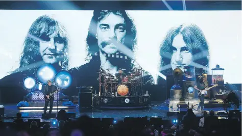  ?? DANNY MOLOSHOK/THE ASSOCIATED PRESS/FILES ?? Alex Lifeson, left, Neil Peart and Geddy Lee of Rush perform in 2013 in Los Angeles as the Canadian band is inducted into the Rock and Roll Hall of Fame. Peart joined Lifeson and Lee in 1974.