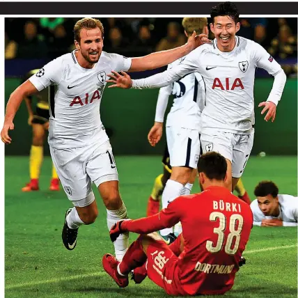  ??  ?? Strike force: Kane (left) congratula­tes Son (right) as Spurs do the double over Dortmund