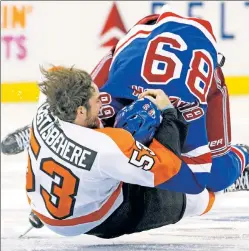  ?? Paul J. Bereswill ?? CRASHING DOWN: Pavel Buchnevich is pulled down to the ice by the Flyers’ Shayne Gostisbehe­re during the first period of the Rangers’ loss Sunday — their fourth straight. The Blueshirts have shown spirit, but are 5-14 since winning on New Year’s Day.