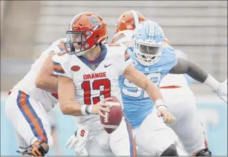  ?? Robert Willett / The News & Observer via AP ?? Syracuse quarterbac­k Tommy Devito had to do a lot of scrambling on Saturday in the Orange’s opener. He completed just 13 of 31 passes for 112 yards.