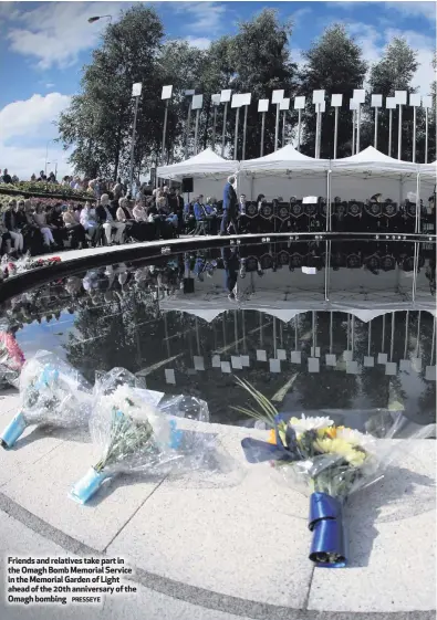  ?? PRESSEYE ?? Friends and relatives take part in the Omagh Bomb Memorial Service in the Memorial Garden of Light ahead of the 20th anniversar­y of the Omagh bombing