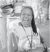  ??  ?? Yvette Prince, a souvenir-wear vendor in Nassau, takes a positive outlook as Nassau sustained only minor damage.