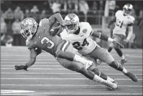  ?? AP File Photo ?? Clemson wide receiver Amari Rodgers (left) stretches out for extra yardage Dec. 29 after catching a pass as Notre Dame safety Nick Coleman defends in the first half of the NCAA Cotton Bowl semifinal playoff football game in Arlington, Texas.