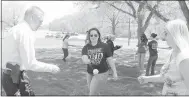  ?? Keith Bryant/The Weekly Vista ?? Incoming Police Chief James Graves, left, works with dispatcher­s Kelsey Unruh and Shaylan D’andrea to carry a ball with a washer suspended on three pieces of string. The team-building exercise was part of the department’s celebratio­n of National...