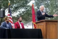  ?? The Sentinel-Record/RICHARD RASMUSSEN ?? Shaun Keefe (from left) and Morgan Wiles listen Wednesday as Gov. Asa Hutchinson speaks in Mountain Pine about the partners’ plans for an industrial park in the Garland County town.