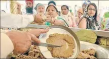  ??  ?? EAT, PRAY, LOVE: Before the parshad, also called degh, is served to devotees, it is dedicated to the kirpan or religious sword or dagger at the ‘kirpan bhent’ ceremony. An Amritdhari (baptised) Sikh chops the degh in a metallic utensil.