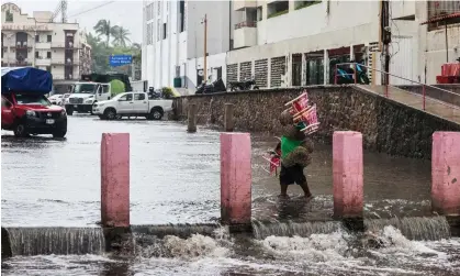  ?? Photograph: David Guzman/EPA ?? A flooded street in Acapulco, Guerrero state, Mexico, as Hurricane Hilary looms.