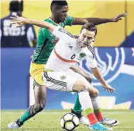  ?? FILE ?? Damion Lowe (left) in action for Jamaica against Mexico’s Erick Torres at this year’s CONCACAF Gold Cup tournament.