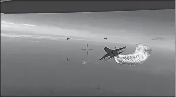  ?? U.S. DEPARTMENT OF DEFENSE VIA AP ?? This photo taken from video released on Thursday shows a Russian Su-27 approachin­g the back of the MQ-9 drone over the Black Sea and beginning to release fuel as it passes, the Pentagon said. The Pentagon has released footage of what it says is a Russian aircraft conducting an unsafe intercept of a U.S. Air Force surveillan­ce drone in internatio­nal airspace over the Black Sea.