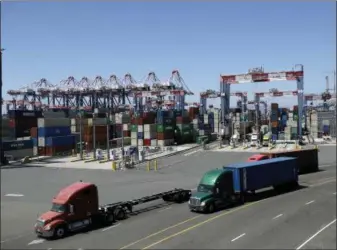  ?? MARCIO JOSE SANCHEZ — THE ASSOCIATED PRESS FILE ?? Trucks travel along a loading dock at the Port of Long Beach in Long Beach. On Oct. 26 the Commerce Department issued the first of three estimates of how the U.S. economy performed in the third quarter.