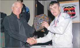  ??  ?? Skye captain Jamie Gillies received the London Shield from Willie Macdonald. Photos: Neil Paterson