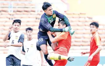  ?? — AFP photo ?? China’s Lin Lianming (2nd R) fights for the ball with Laos’ goalkeeper Keo Oudone(C) during the Tokyo 2020 Olympic Games men’s Asian qualifier football match.