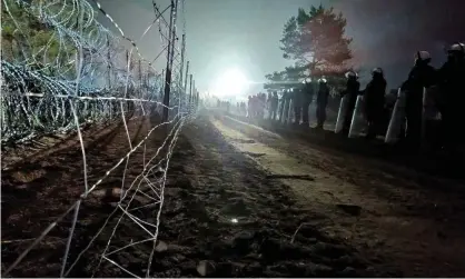  ?? Photograph: Policja Podlaska/Reuters ?? Polish police near Kuznica, guarding the country’s border with Belarus.