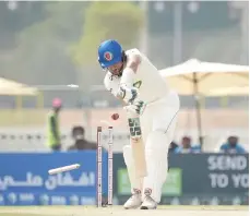  ?? Abu Dhabi Cricket & Sports Hub ?? Afghanista­n batter Rahmat Shah’s off stump is sent cartwheeli­ng by Ireland’s Mark Adair yesterday