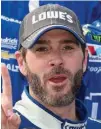  ?? Associated Press ?? Jimmie Johnson, left, poses in Victory Lane after he won a NASCAR Cup series auto race Sunday at Dover Internatio­nal Speedway in Dover, Del.