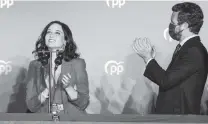  ?? BERNAT ARMANGUE AP ?? Isabel Diaz Ayuso, left, and Popular party leader Pablo Casasdo celebrate election results in Madrid, Spain, in May 2021.