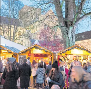  ??  ?? CHRISTMAS CHEER: One hundred market stalls line the cathedral grounds in Winchester