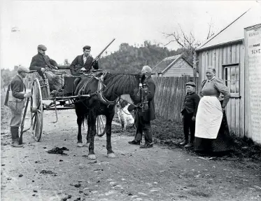  ??  ?? Hans Olsson, the last tollkeeper at the settlement called Gorge, at the Woodville end of the gorge, collecting tolls from a hunting party, before 1913.