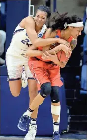  ?? Jessica Hill / The Associated Press ?? Connecticu­t’s Napheesa Collier (left) and Syracuse’s Briana Daycompete for a rebound during the second half of Monday’s second-round game.