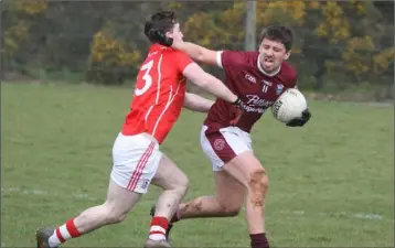  ??  ?? Ciarán Lyng of St. Martin’s holding off John Tubritt, the sole Fethard scorer.