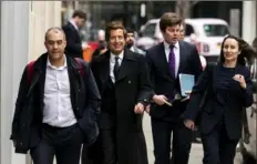  ?? Jordan Pettitt/PA via AP ?? Attorney David Sherborne, second from left, walks Wednesday near the Rolls Buildings in central London. Mr. Sherborne, Prince Harry's lawyer, says the cover-up of unlawful informatio­n gathering at British tabloids owned by Rupert Murdoch went all the way to the top.