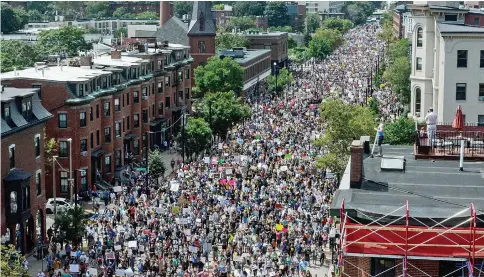  ??  ?? A large crowd of people march towards the Boston Commons to protest the Boston Free Speech Rally. — Reuters photo