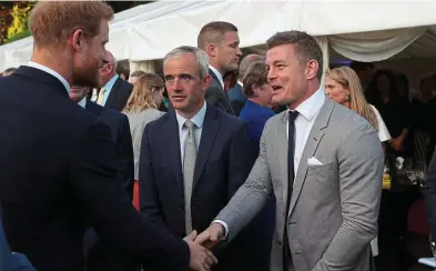  ??  ?? Sporting life: Prince Harry meets Ruby Walsh and Ireland rugby legend Brian O’Driscoll