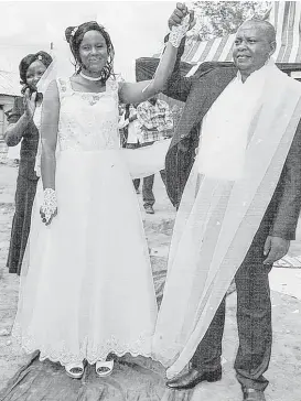  ?? Fredrick Nzwili / Religion News Service ?? Pastor Samson Mulinge Mutuse celebrates his wedding to Evelyn Mueni Mulinge at Deliveranc­e Church in Nthange, Kenya, on Nov. 25. Each lost a first spouse to AIDS.